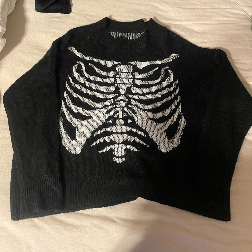 Black knitted sweater with rib cage design
